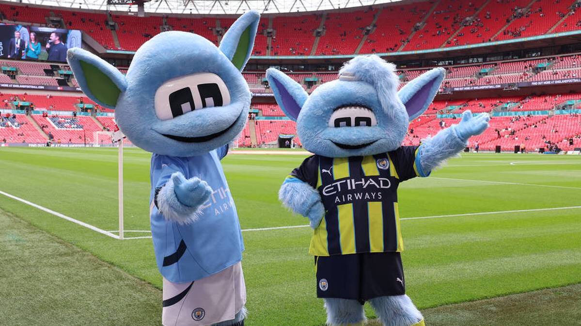 The mascots "Moonchester" (left) and "Moonbeam" accompany Manchester City