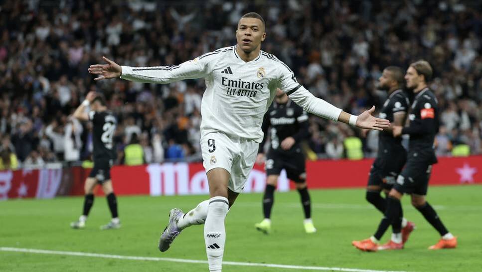 Kylian Mbappé cheers in Real Madrid jersey