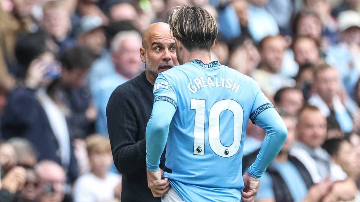 Pep Guardiola in conversation with Jack Grialish