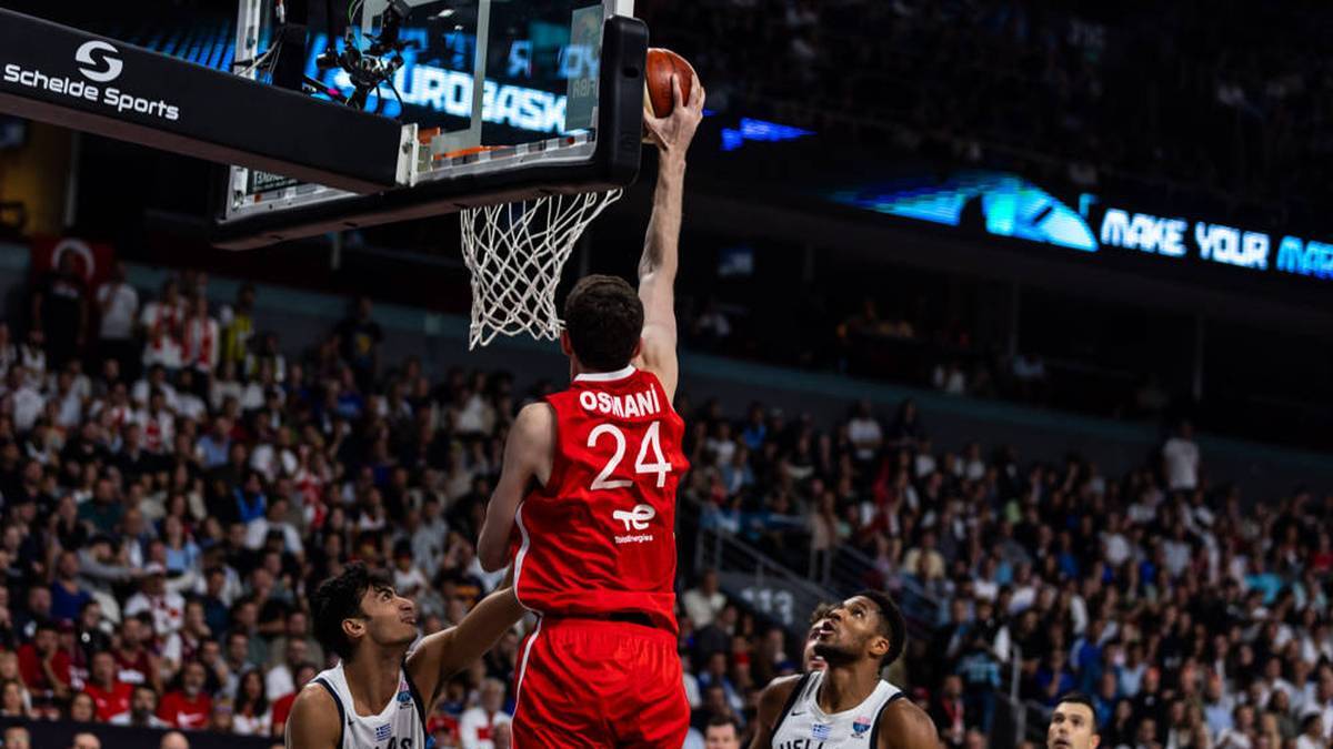 Ercan Osmani climbs up to the basket