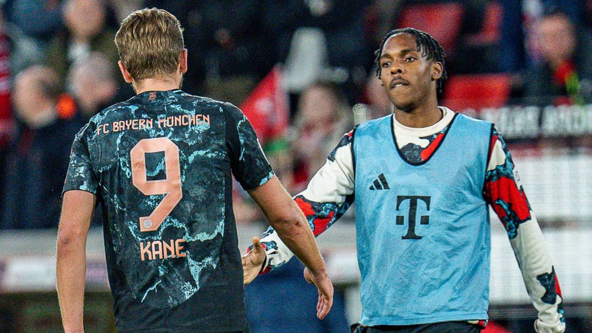 Harry Kane offers Mathys Tel (r.) his help