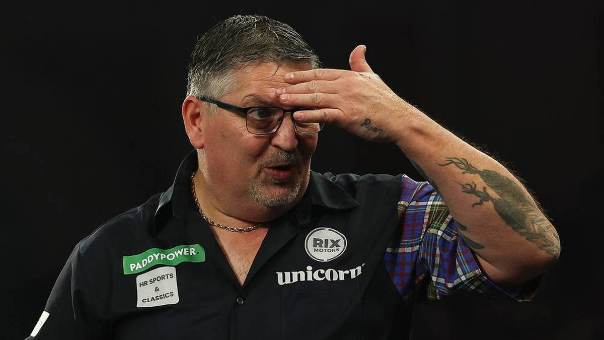 Gary Anderson clutches his forehead