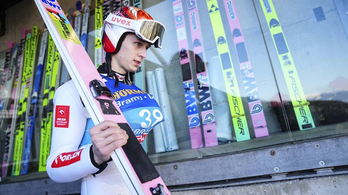 Pawel Wasek carries his skis